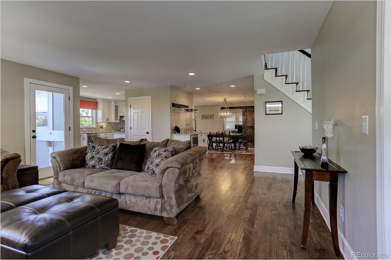 8401 Sweet Water Road Lone Tree, CO 80124 - Photo 9 of 35 a living room with furniture and a wooden floor