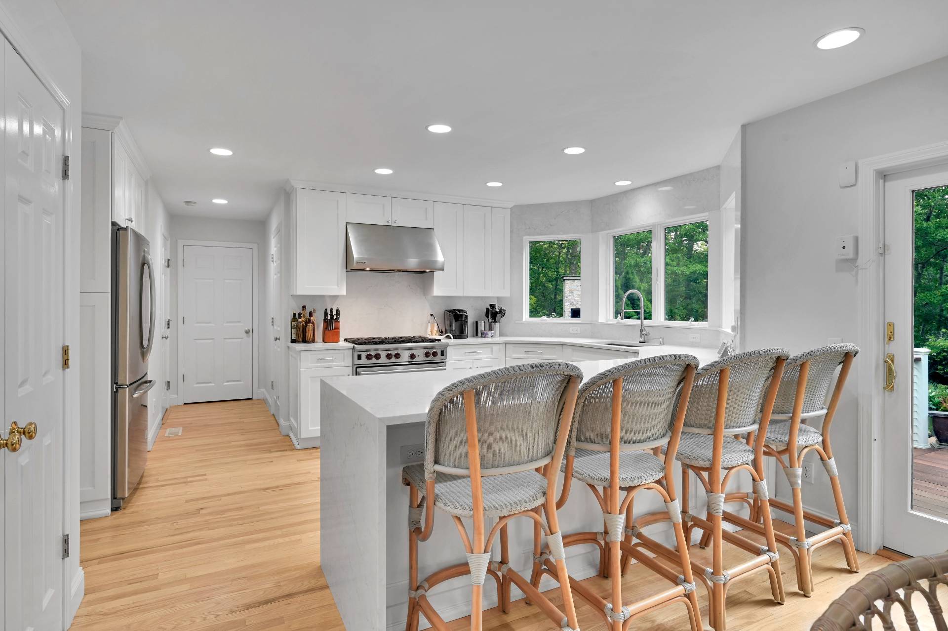 105 Northside Drive Sag Harbor, NY 11963 - Photo 12 of 33 a kitchen with stainless steel appliances granite countertop a sink a stove a refrigerator and island with wooden floor
