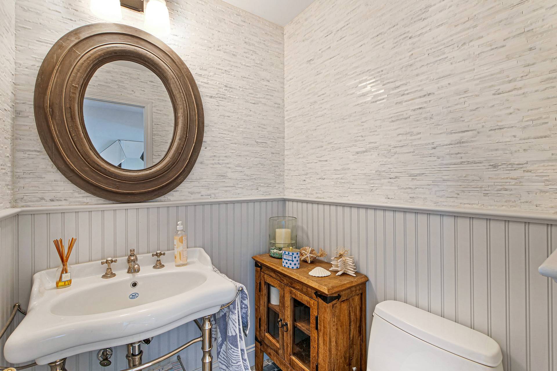 105 Northside Drive Sag Harbor, NY 11963 - Photo 16 of 33 a bathroom with a sink a toilet and a mirror