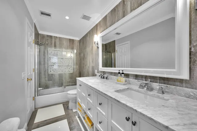 a bathroom with a granite countertop sink mirror and double