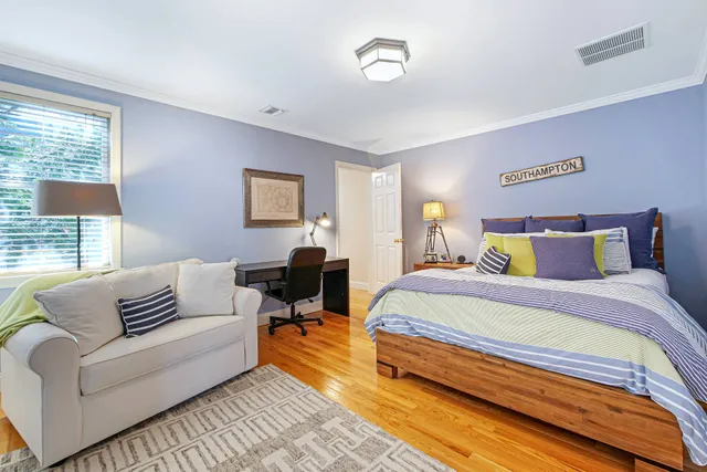 a spacious bedroom with a bed and a couch