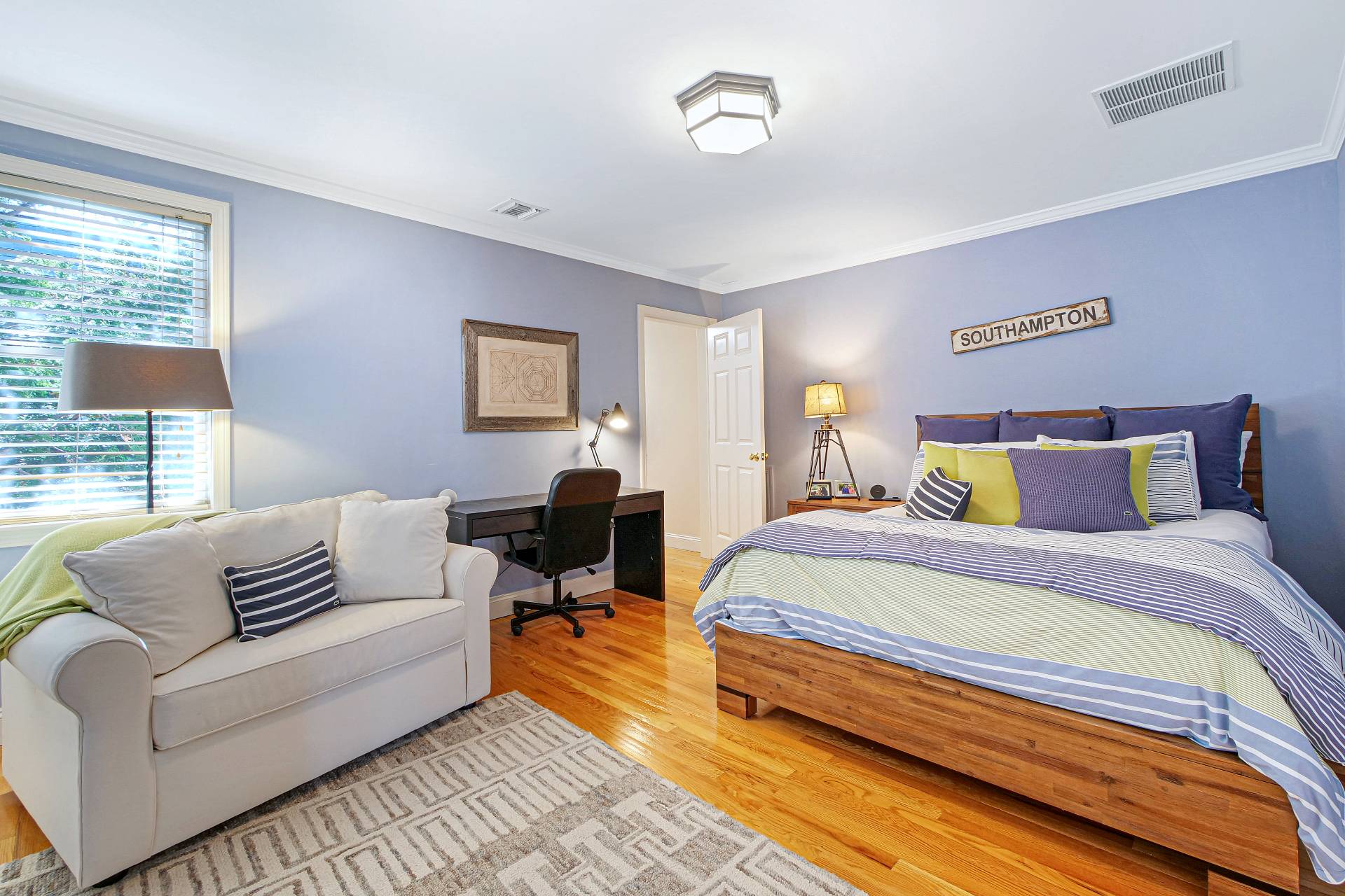 105 Northside Drive Sag Harbor, NY 11963 - Photo 22 of 33 a spacious bedroom with a bed and a couch