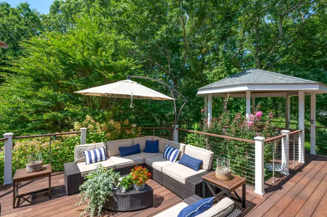 a patio with hardwood table and chairs