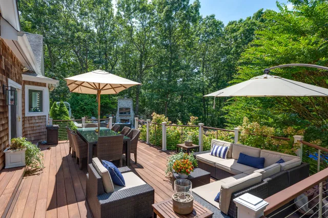 a view of a patio with furniture and a backyard