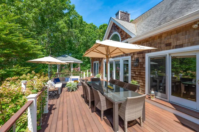 a view of a dinning table and chairs in patio of the house