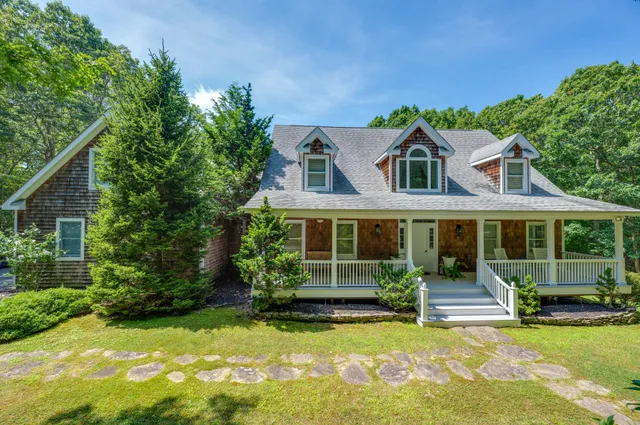 a front view of a house with a yard table and chairs