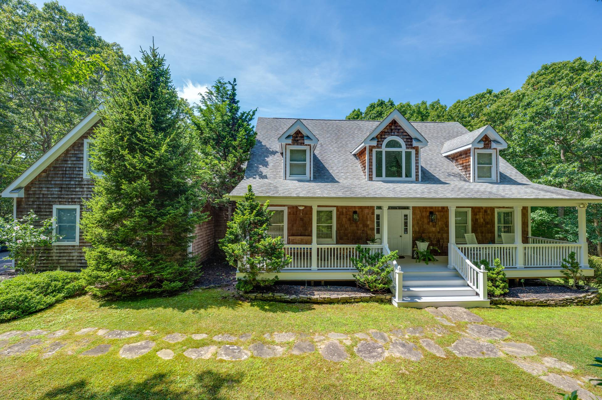 105 Northside Drive Sag Harbor, NY 11963 - Photo 7 of 33 a front view of a house with a yard table and chairs