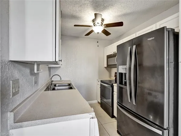 a kitchen with appliances and cabinets