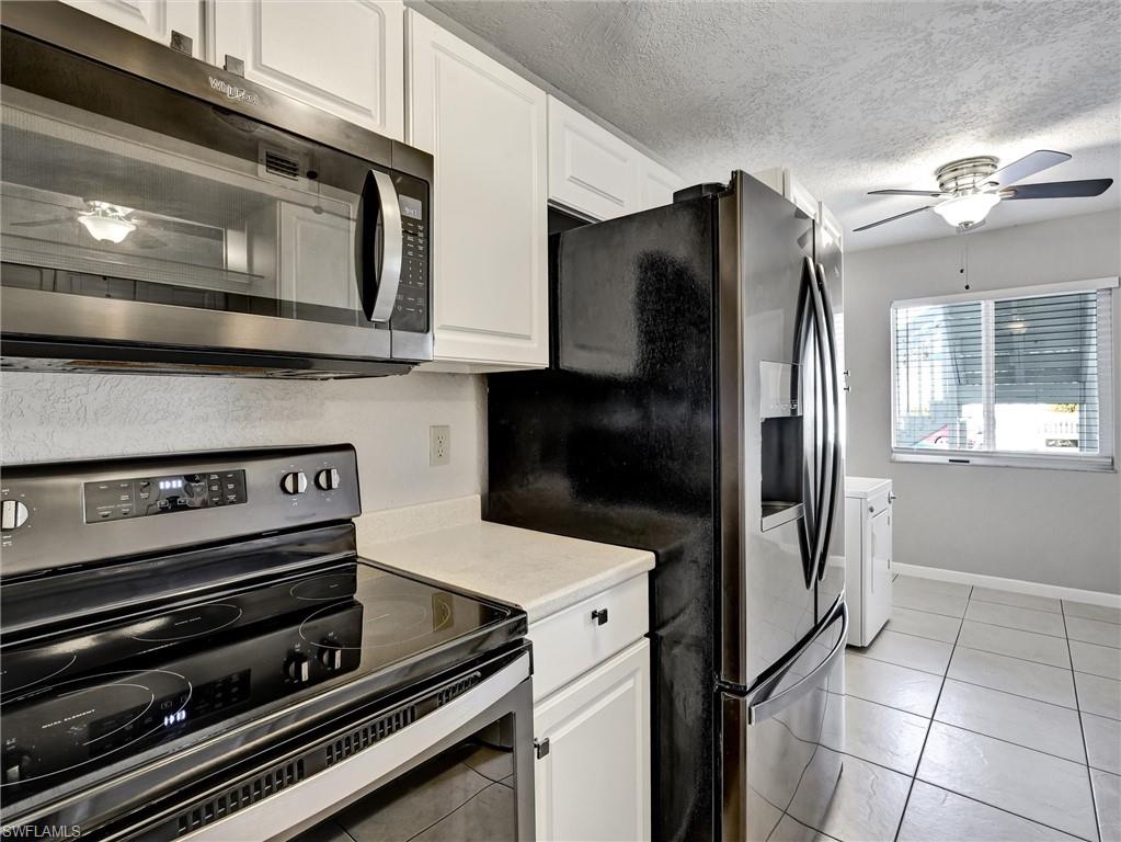 4621 Bayshore Drive, Unit Q1 Naples, FL 34112 - Photo 13 of 25 a kitchen with appliances and cabinets
