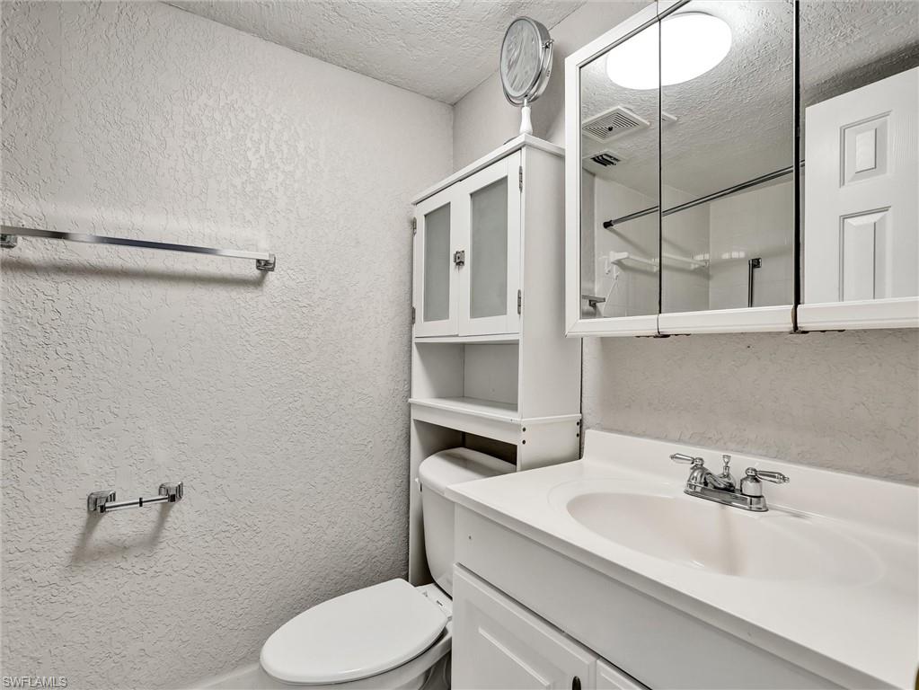 4621 Bayshore Drive, Unit Q1 Naples, FL 34112 - Photo 19 of 25 a bathroom with a sink a toilet and shower