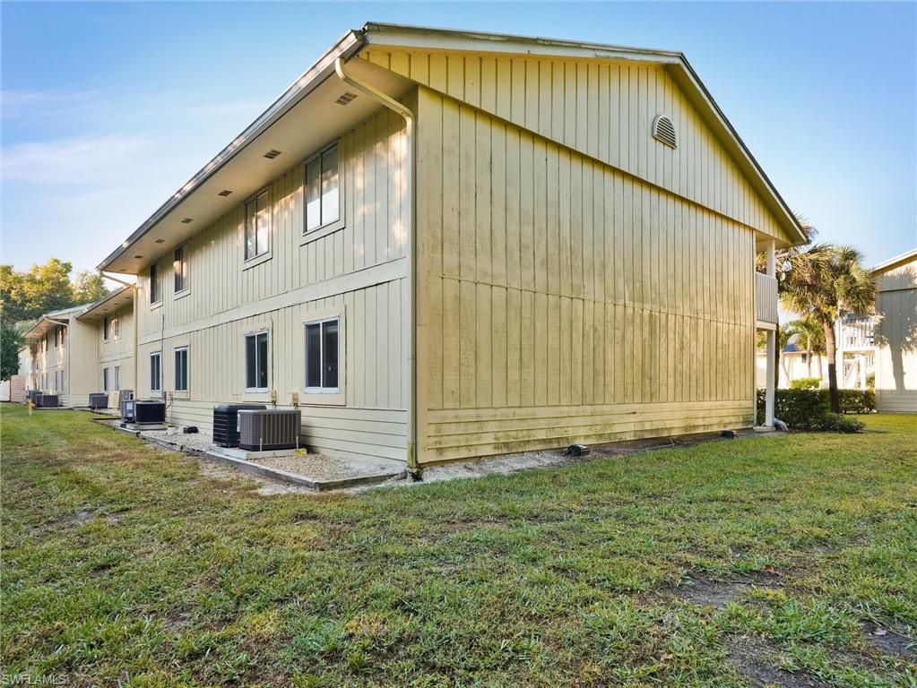 4621 Bayshore Drive, Unit Q1 Naples, FL 34112 - Photo 25 of 25 a front view of a house with a yard