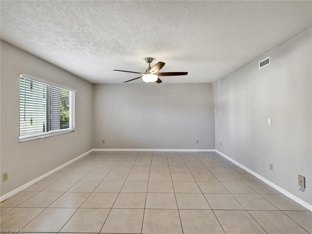 4621 Bayshore Drive, Unit Q1 Naples, FL 34112 - Photo 5 of 25 a view of an empty room with a window