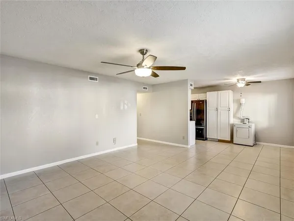 a view of an empty room and a ceiling fan