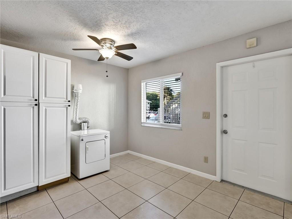 4621 Bayshore Drive, Unit Q1 Naples, FL 34112 - Photo 10 of 25 a view of an empty room with windows and cabinet