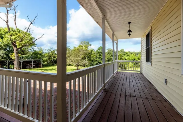 a view of balcony with wooden floor and outdoor space