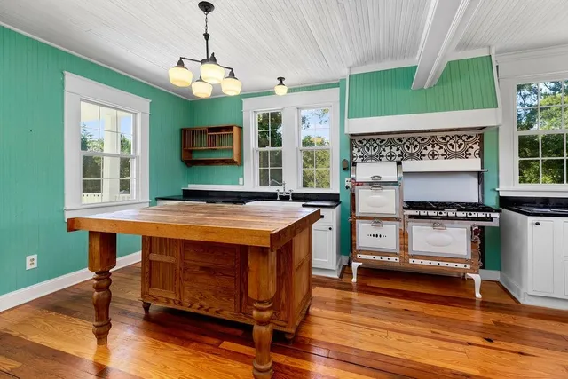 a kitchen that has a sink and a stove in it