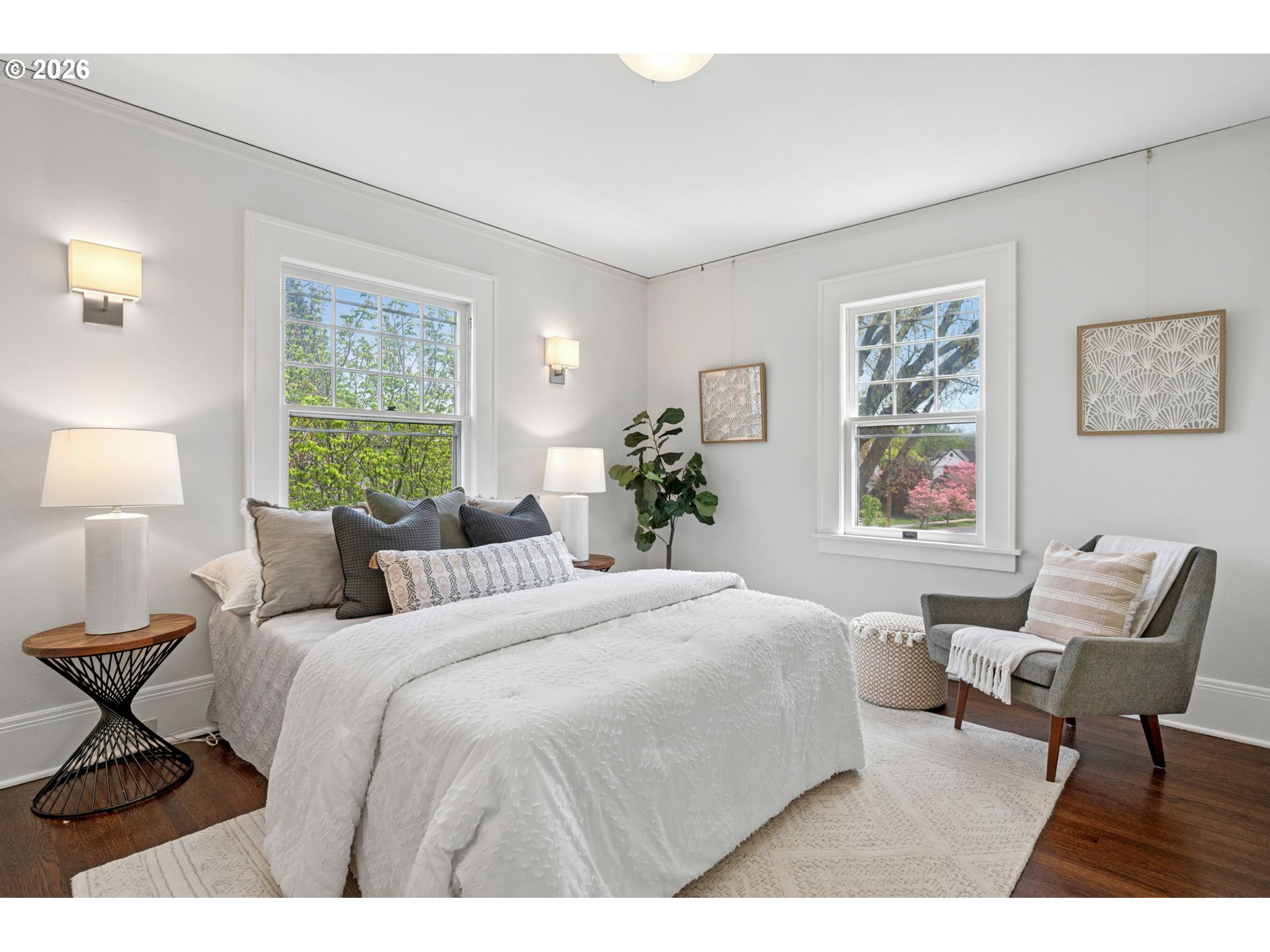 3434 Northeast Peerless Place Portland, OR 97232 - Photo 26 of 40 a bedroom with a bed a chair and next to a window