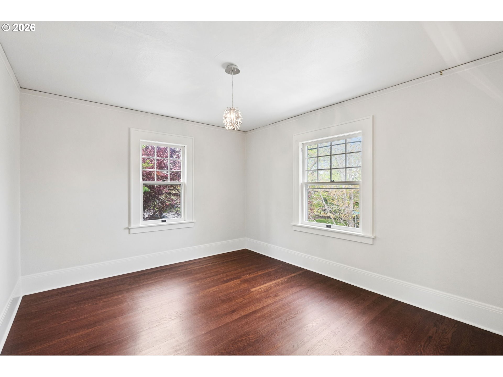3434 Northeast Peerless Place Portland, OR 97232 - Photo 29 of 40 an empty room with wooden floor and windows