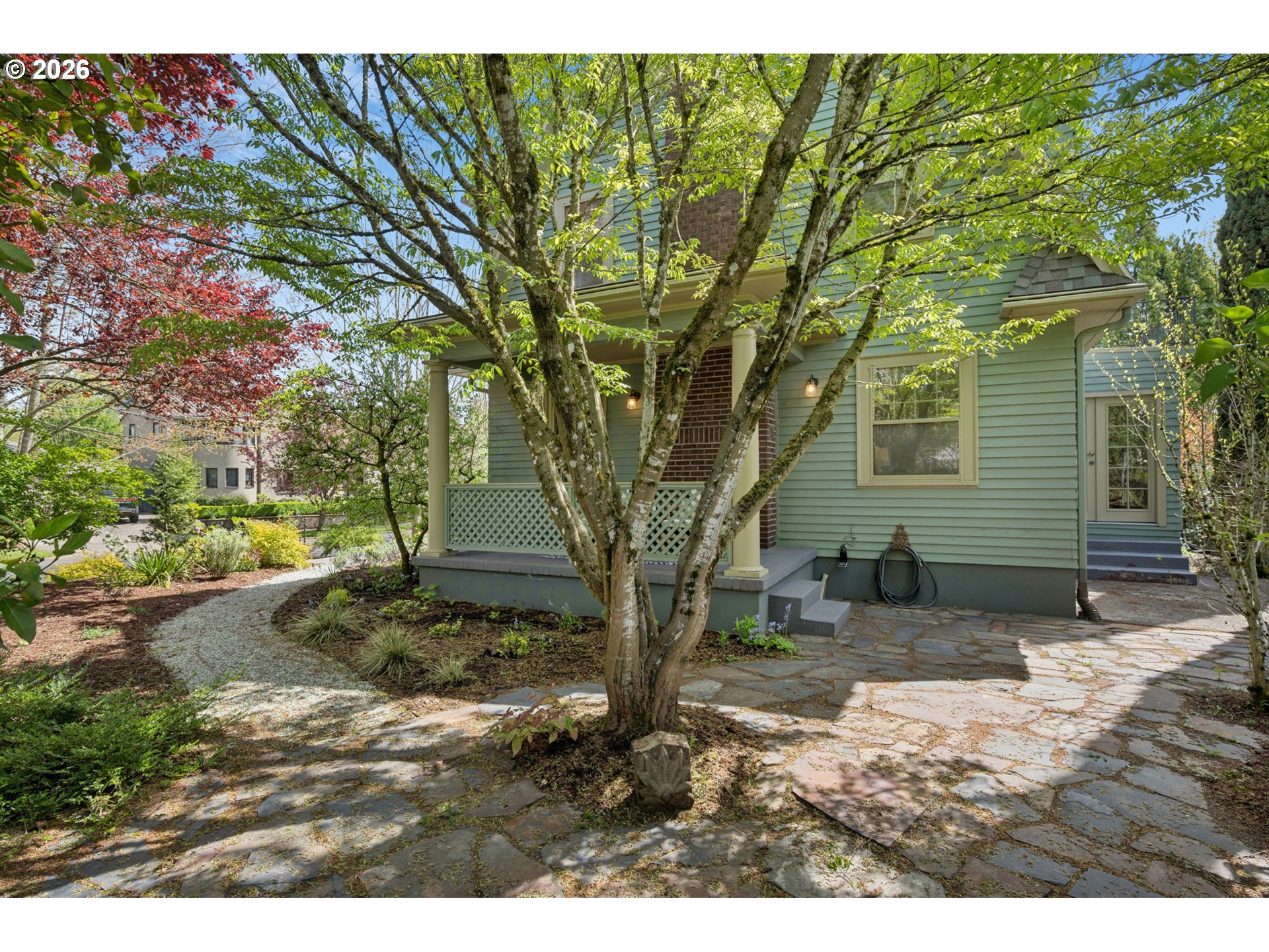 3434 Northeast Peerless Place Portland, OR 97232 - Photo 35 of 40 a backyard of a house with a large tree