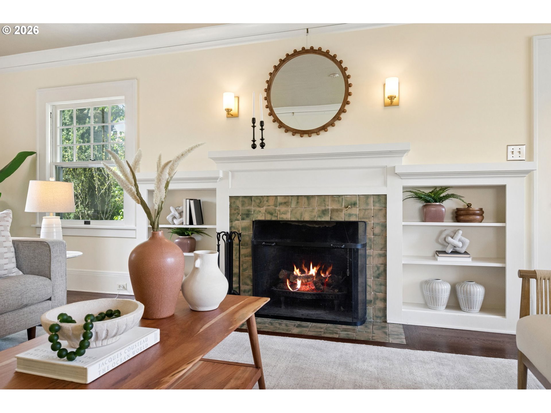 3434 Northeast Peerless Place Portland, OR 97232 - Photo 9 of 40 a living room with furniture a fireplace and a large mirror
