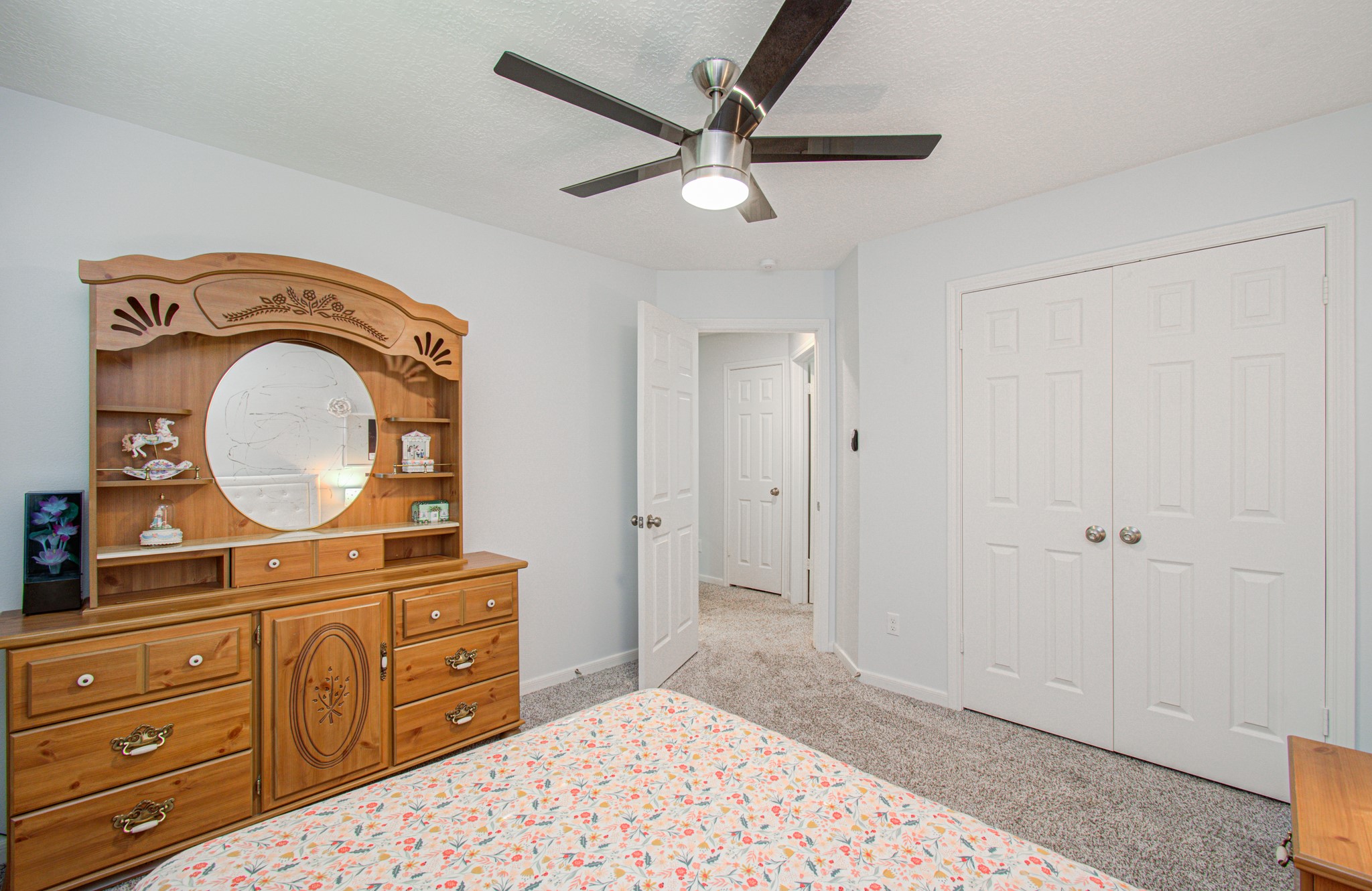 22927 Northoak Forest Lane Spring, TX 77389 - Photo 24 of 37 a bedroom with a bed and a mirror on the dresser