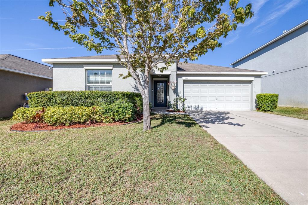 a front view of a house with garden