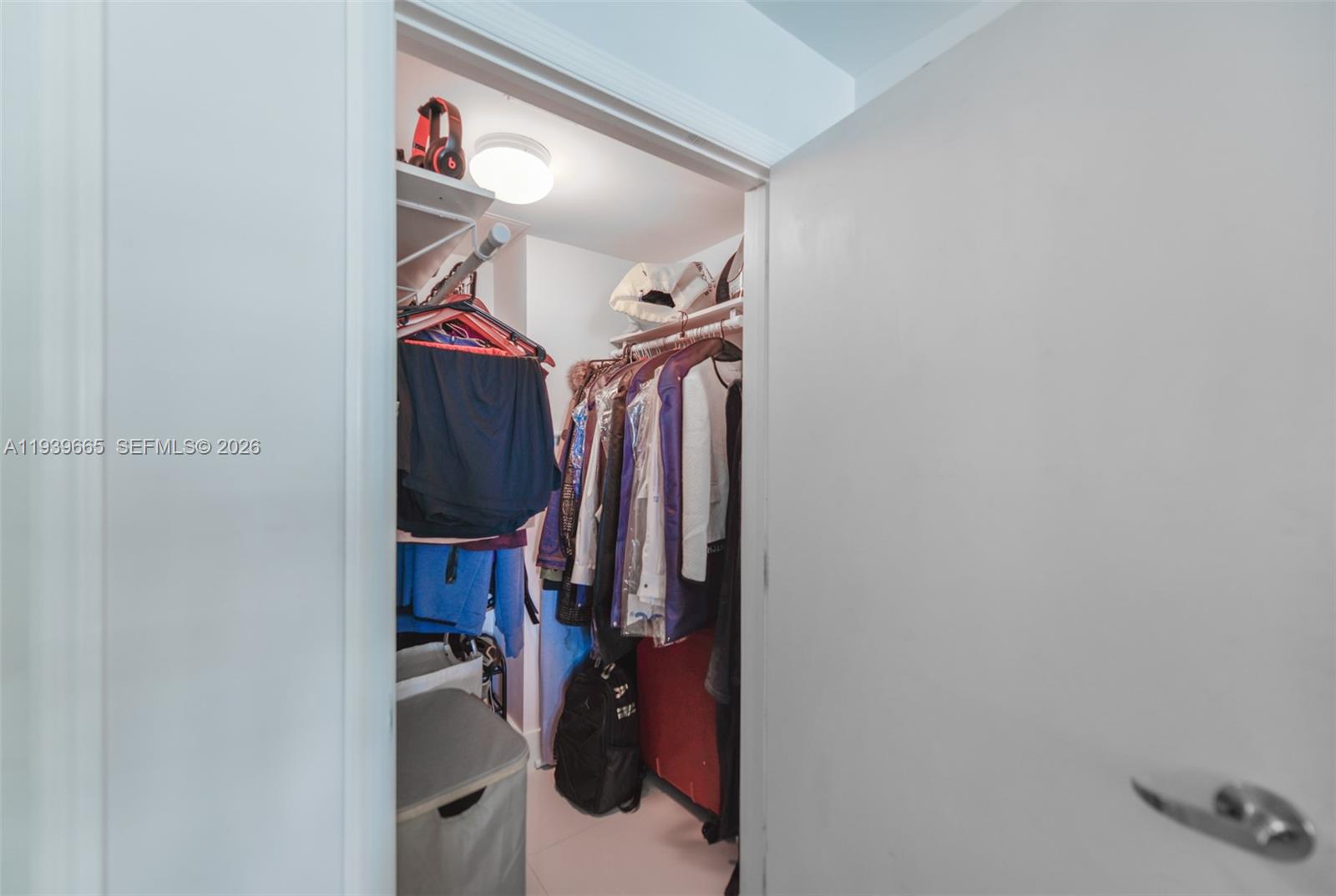 60 Southwest 13th Street, Unit 2404 Miami, FL 33130 - Photo 13 of 28 a view of walk in closet with clothes and shoes