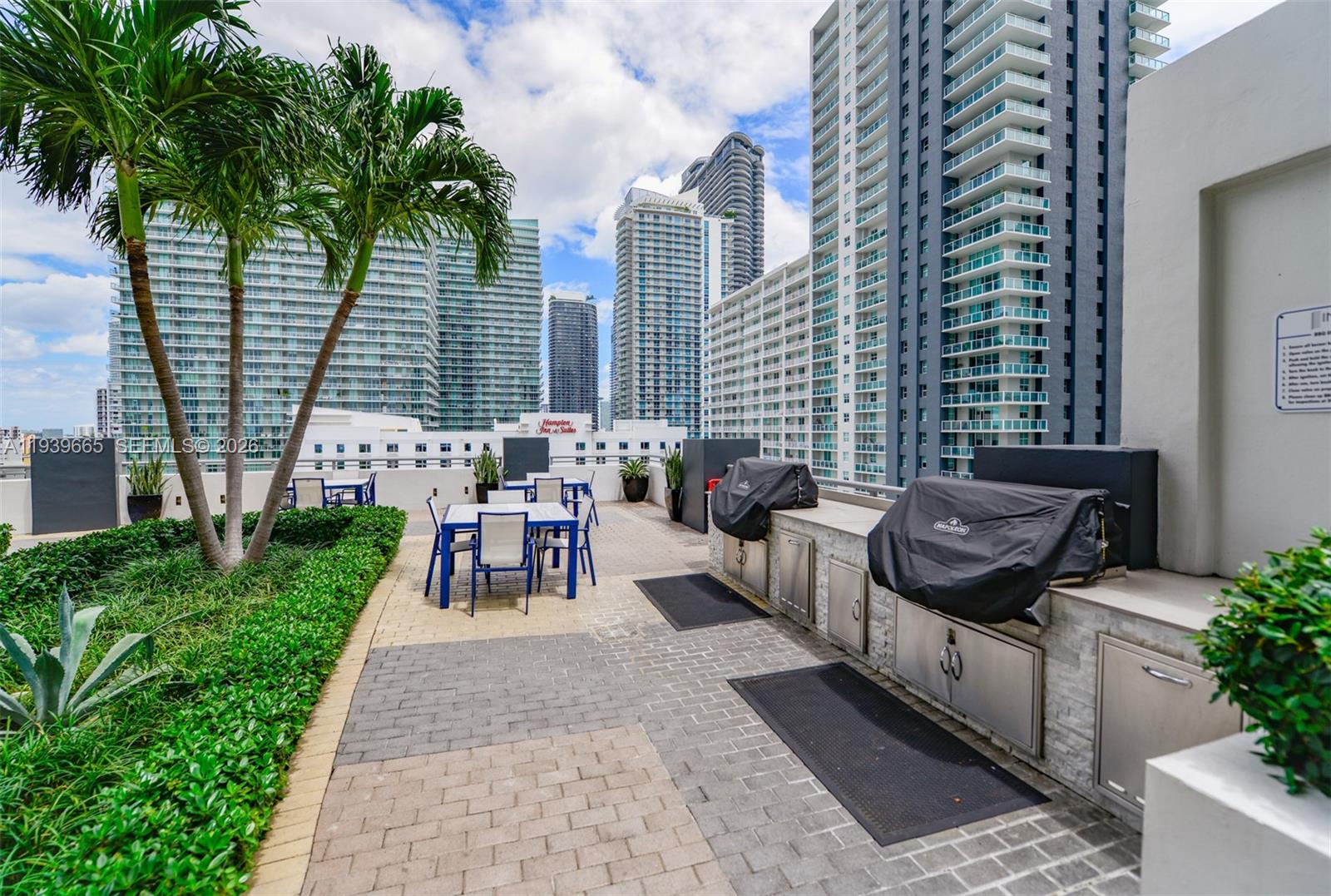60 Southwest 13th Street, Unit 2404 Miami, FL 33130 - Photo 27 of 28 a view of a patio with table and chairs and potted plants