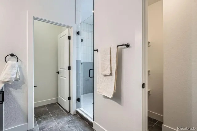 a bathroom with a shower and a sink