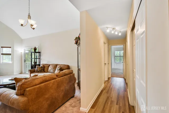 a living room with furniture and a chandelier
