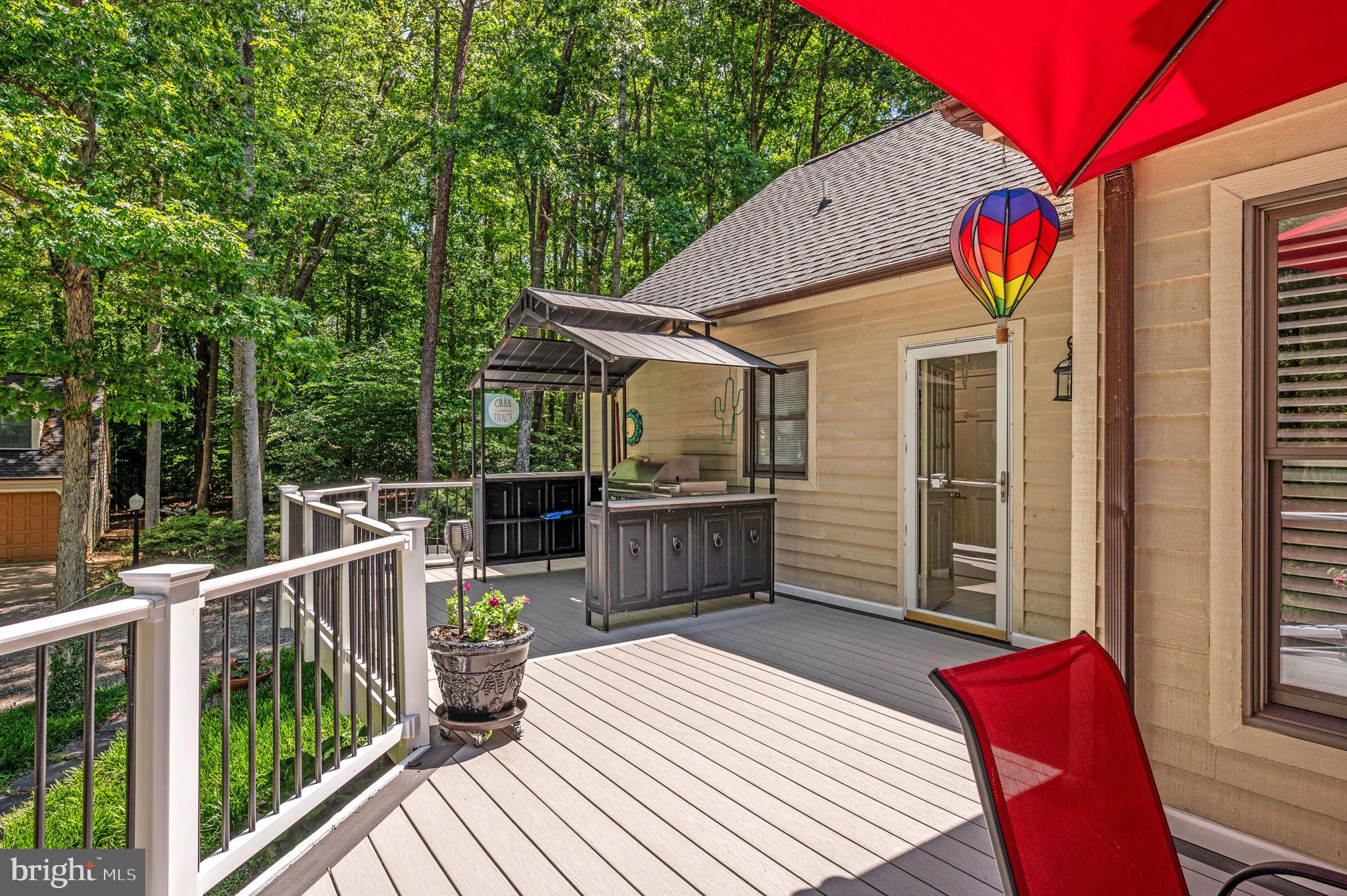 11105 Waddell Road Bumpass, VA 23024 - Photo 63 of 76 a view of a wooden deck and a backyard