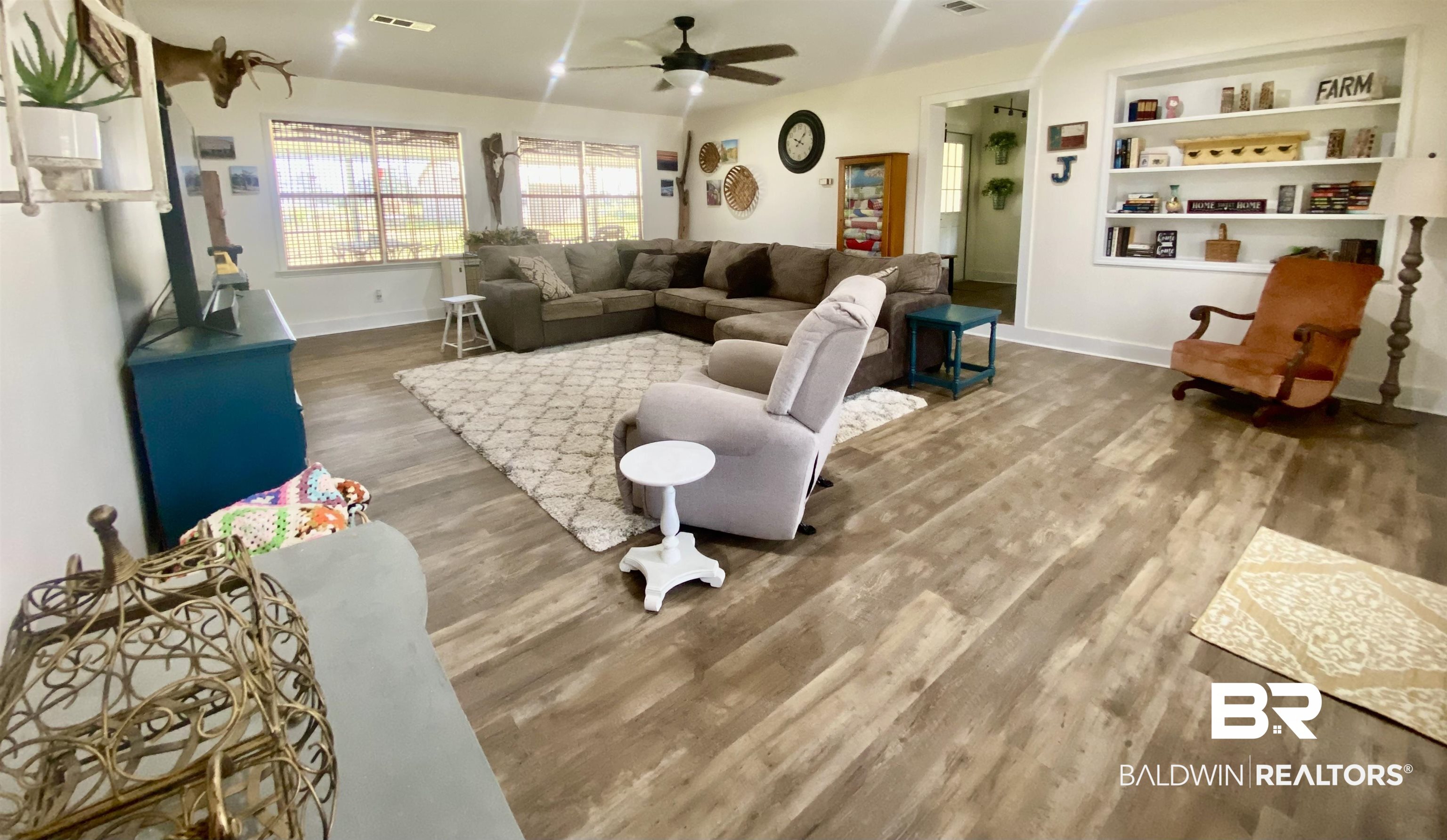 531 Highway 136 Monroeville, AL 36460 - Photo 3 of 48 Living room featuring ceiling fan, built in shelves, and hardwood / wood-style flooring