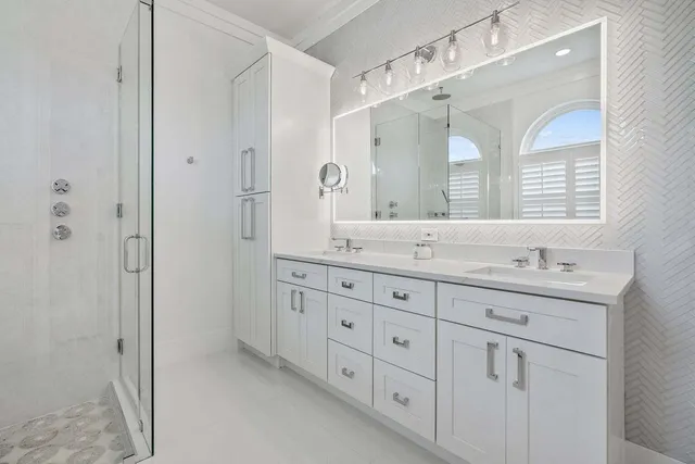 a bathroom with double sink and a mirror