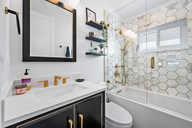 a bathroom with a sink a toilet and bathtub