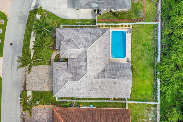an aerial view of a house with a yard