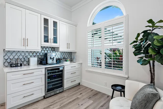 a kitchen with granite countertop a stove a sink and a window