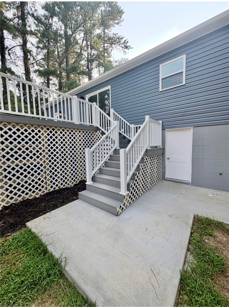 1904 East Calhoun Street Anderson, SC 29621 - Photo 30 of 36 A well-maintained deck and staircase offer seamless access to the outdoors, complementing the home's sturdy siding.