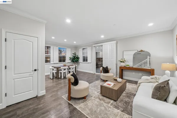 a view of a dining room with furniture and a potted plant