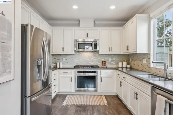 a kitchen with a refrigerator a stove top oven a sink and dishwasher