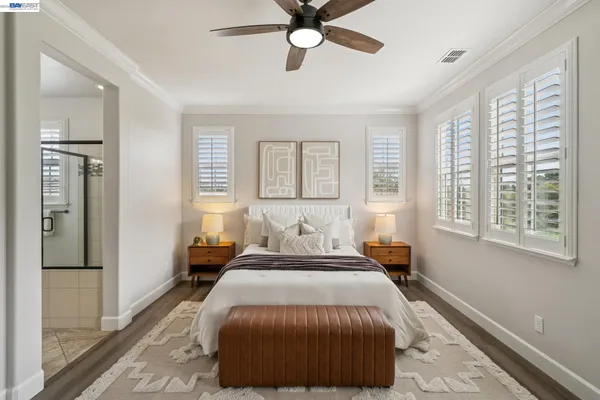 a bedroom with a bed and ceiling fan