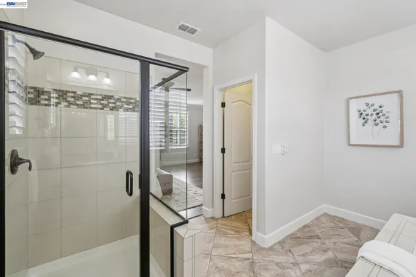 a bedroom with a bed and a painting on the wall