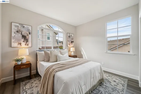 a bedroom with a bed and a potted plant