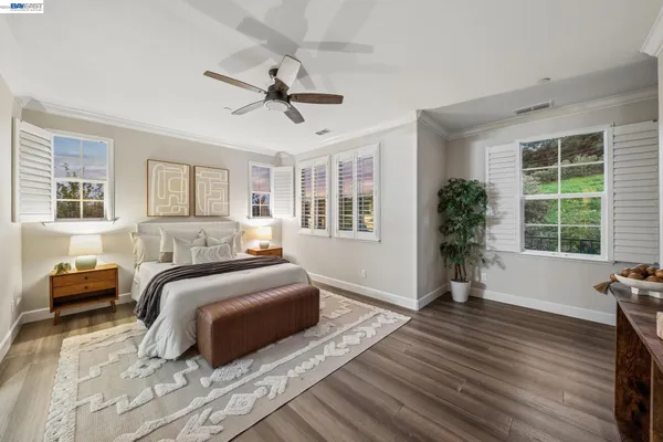 a bathroom with a walk in closet and wooden floor