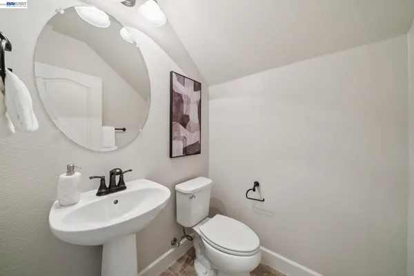 a backyard with table and chairs and potted plants