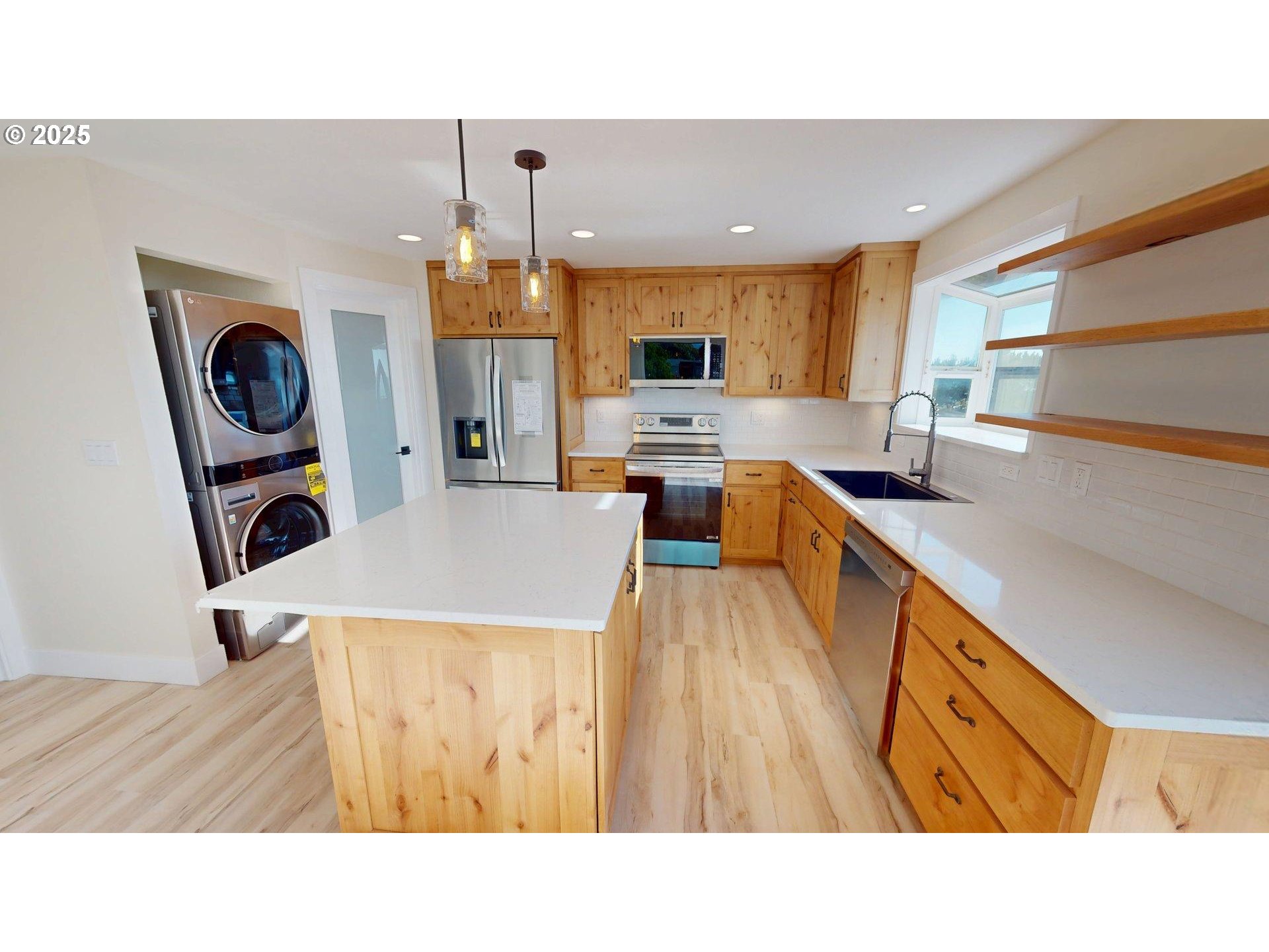 33616 Ophir Road Gold Beach, OR 97444 - Photo 16 of 48 a kitchen with a stove a refrigerator a sink dishwasher with a dining table and chairs