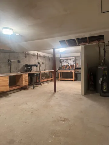 an empty room with furniture and a flat screen tv