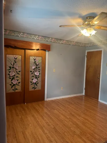 an empty room with window and bathroom