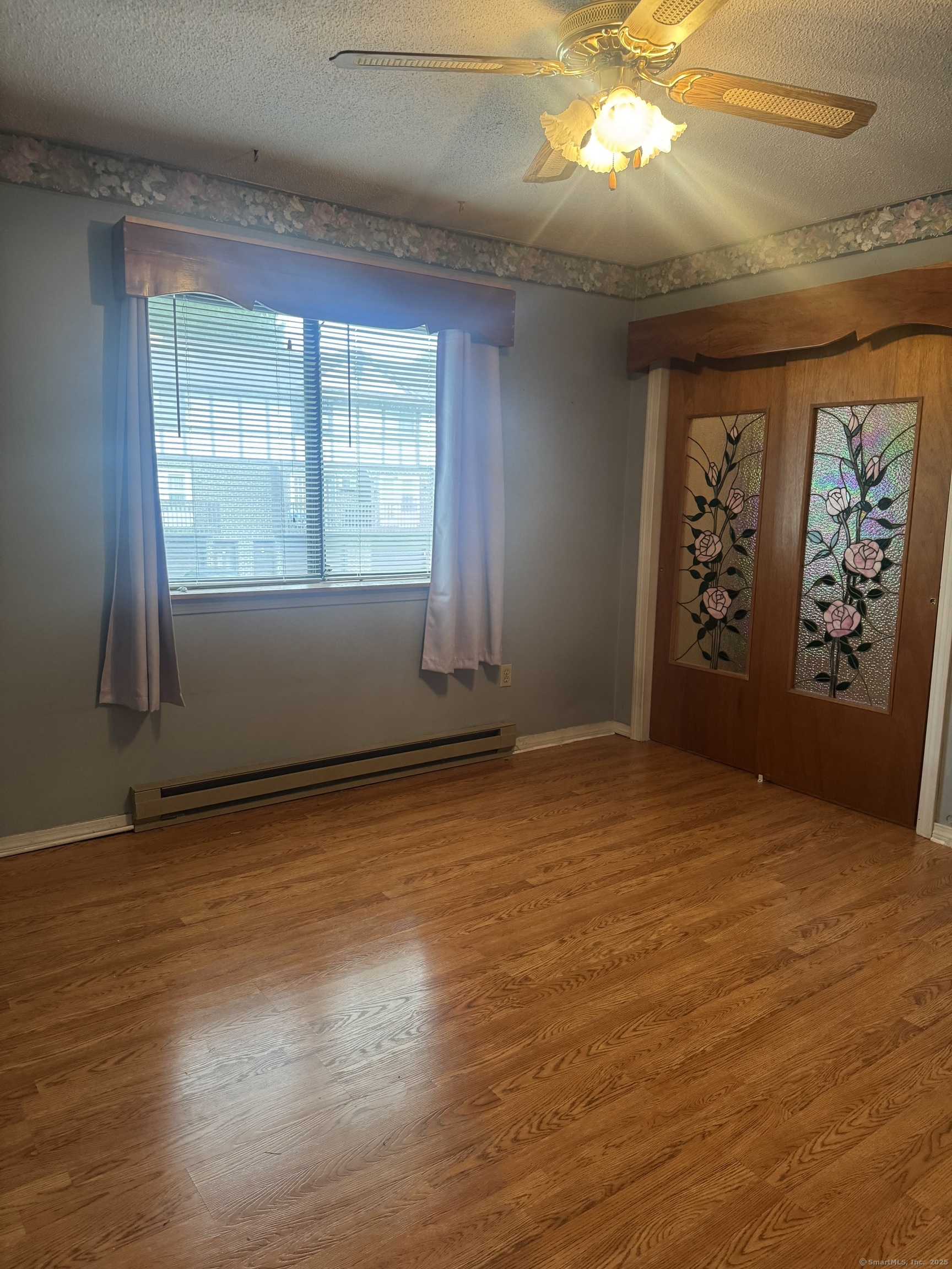 260 Scott Road, Unit 1 Waterbury, CT 06705 - Photo 5 of 11 an empty room with wooden floor and windows
