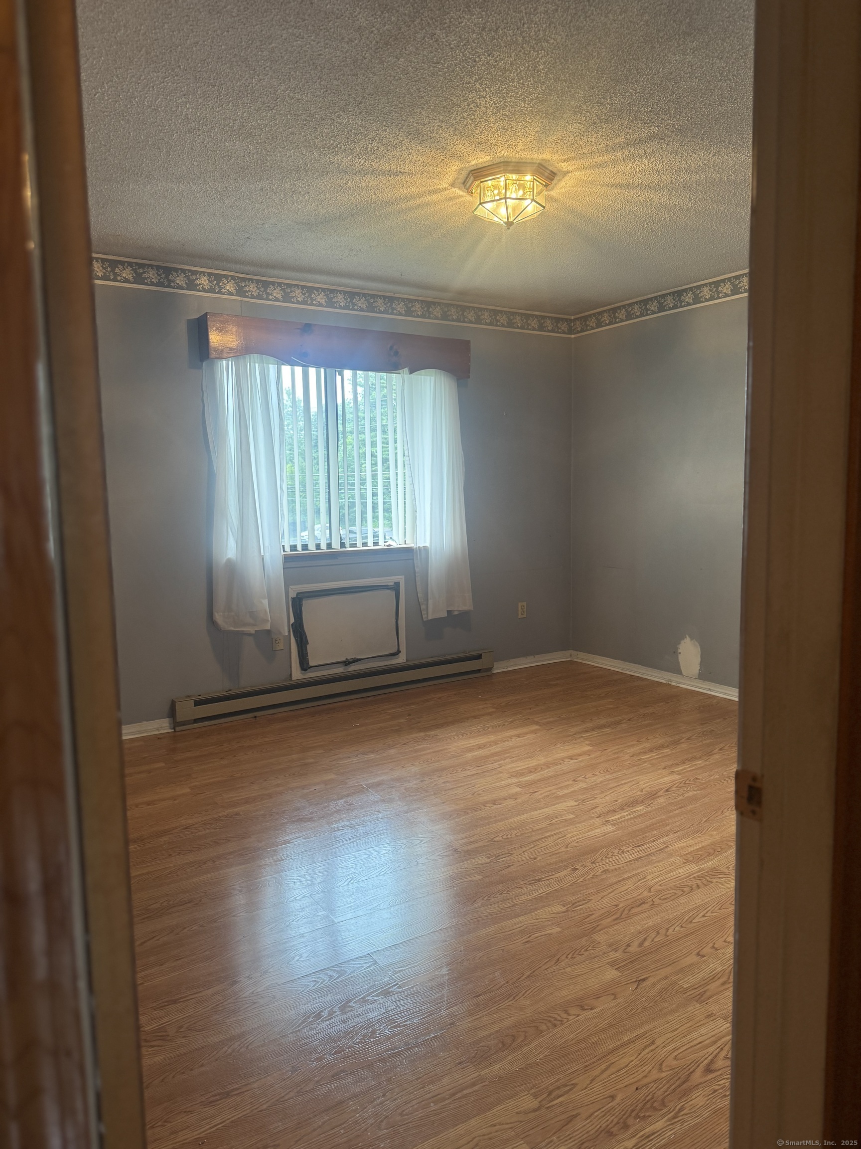 260 Scott Road, Unit 1 Waterbury, CT 06705 - Photo 10 of 11 en empty room with windows and wooden floor