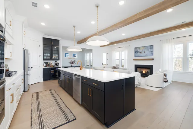 a large kitchen with stainless steel appliances kitchen island granite countertop a sink and cabinets